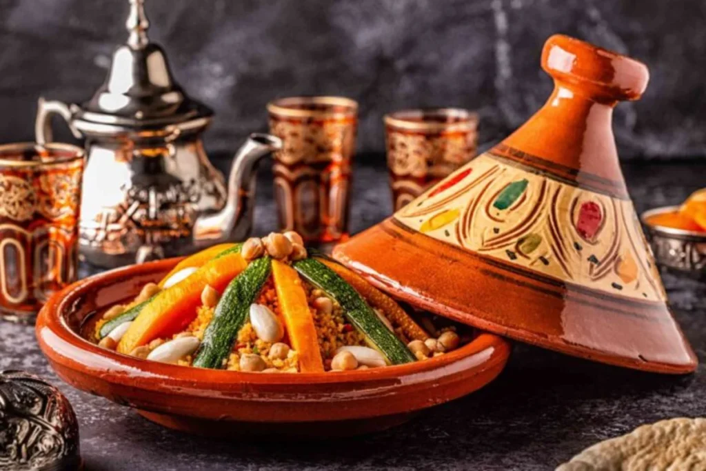 Tajine pot with spices and fresh vegetables